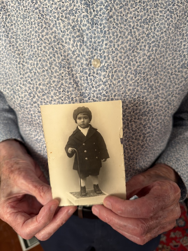 Elly Gotz holding a childhood photograph.