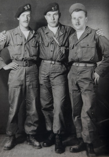 A historical photograph of three soldiers in uniform.