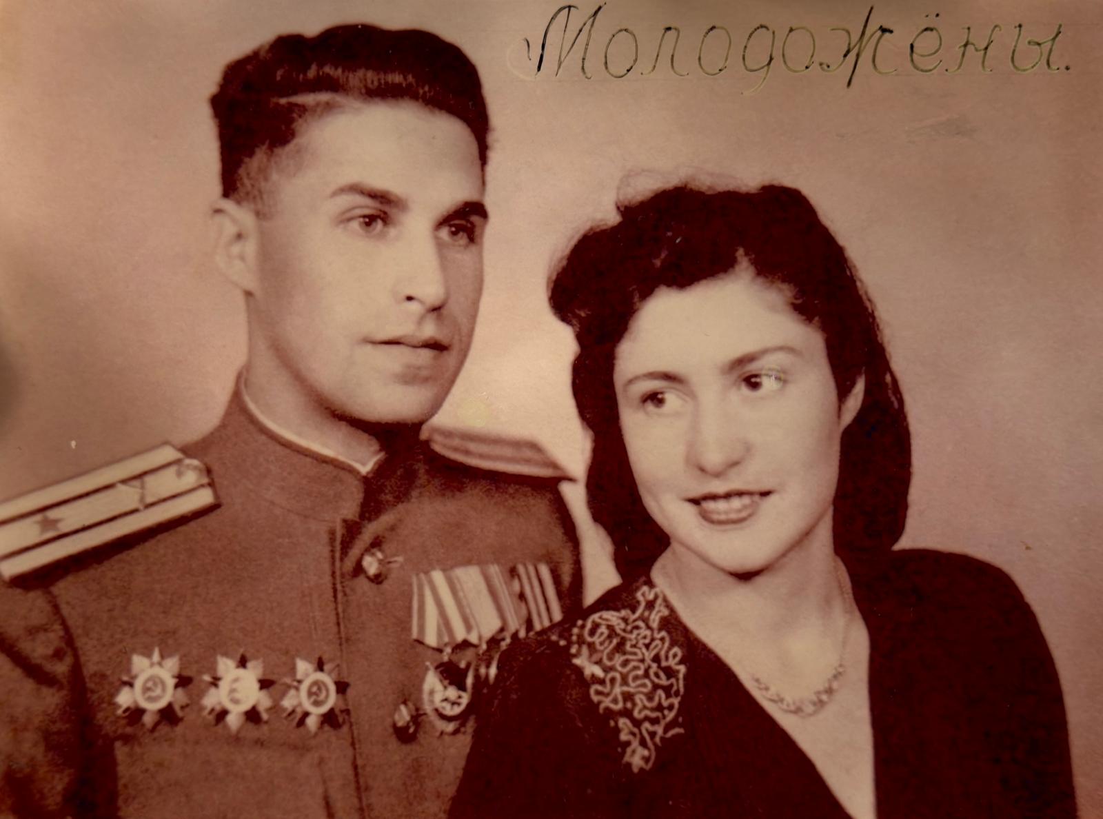 Historical photograph showing Leonid Rozenberg in uniform beside a woman.