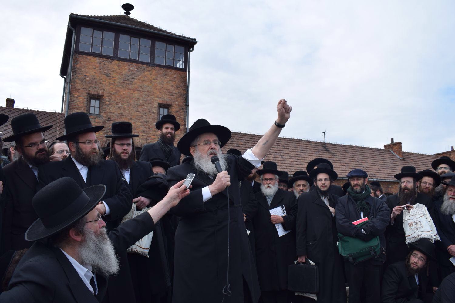 Rabbi Nissen Mangel speaking at Auschwitz-Birkenau.