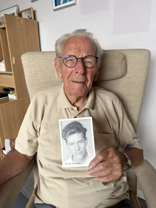 Ejler Borch holding a historical portrait of himself.