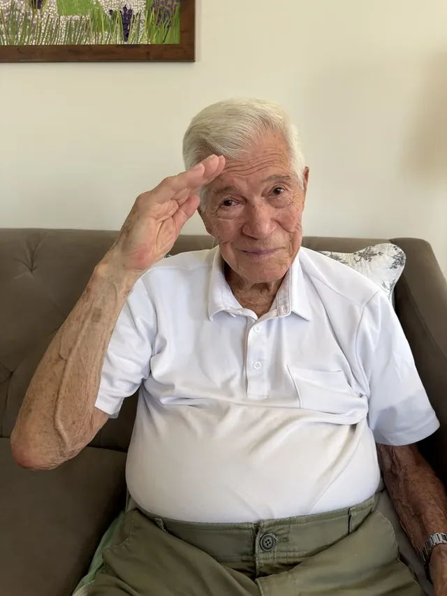 John Banham saluting.