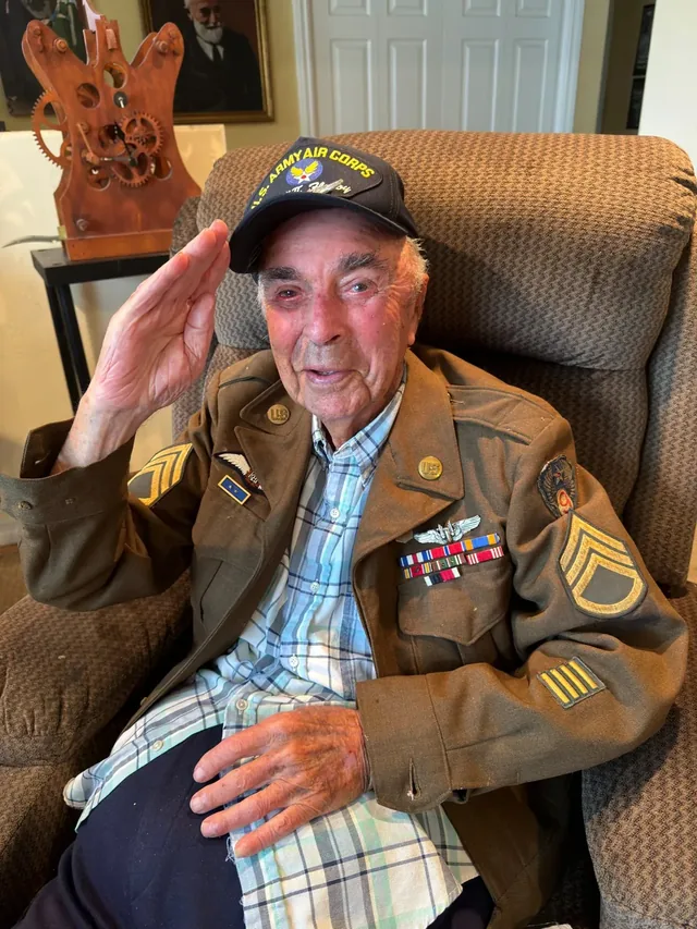 Len Zerlin saluting in his Army uniform and service cap.