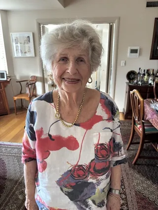 Litzi Lemberg standing in her home.