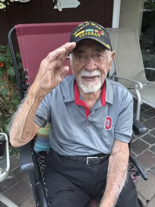 Stanley Maybruck saluting during his meeting with historian Jiri Kluc.
