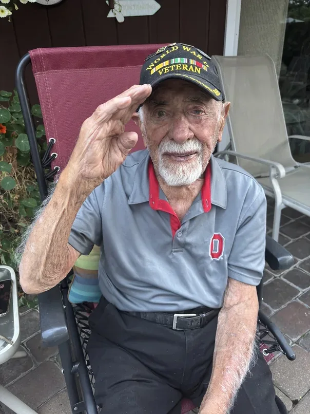 Stanley Maybruck saluting during his meeting with historian Jiri Kluc.