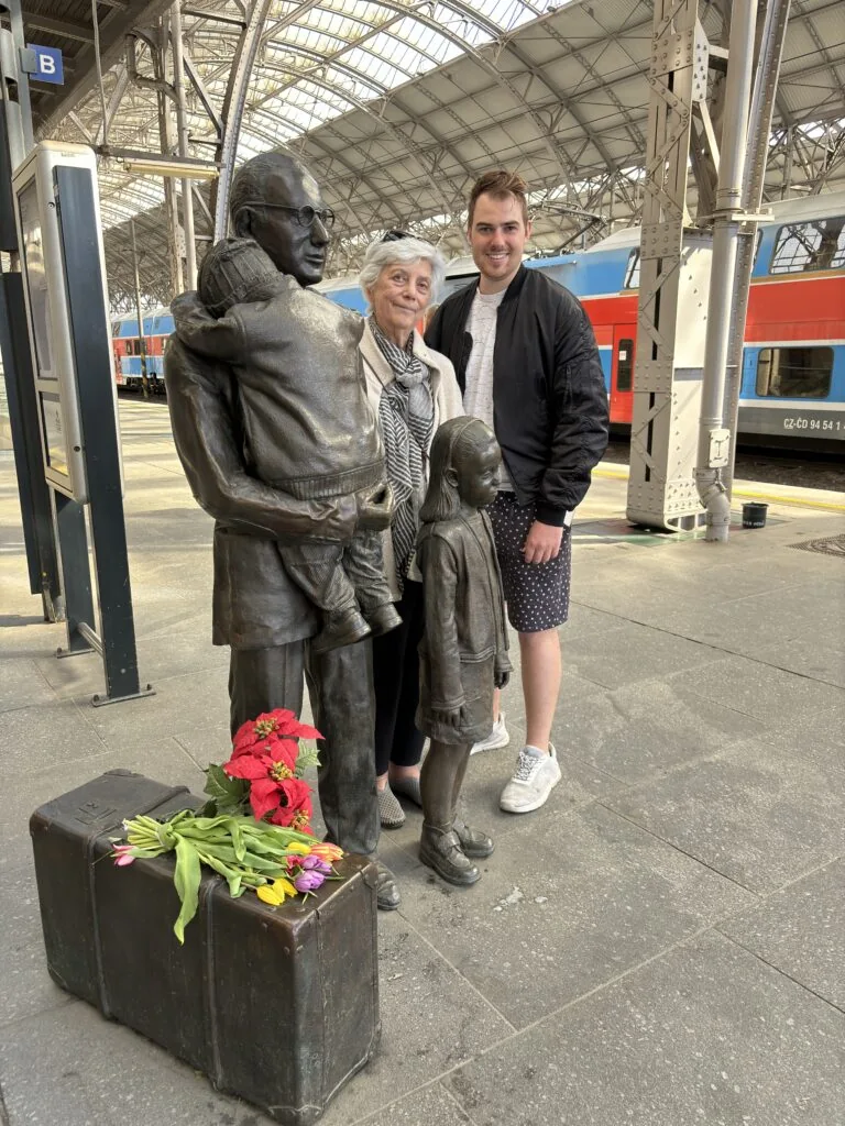 With Prague Kindertransport survivor Zuzana Munk. I gave her and her family a WWII tour in Prague, and when we reached the platform where children had boarded the trains, Zuzana revealed who she was—I had no idea. It was the first time she had ever returned to the train station where she said goodbye to her parents and left for England. She later reunited with her family and has lived in the United States ever since. Photo taken in April 2024.