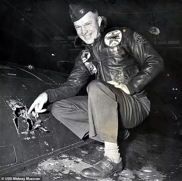Royce Williams pointing to battle damage on his aircraft after the 1952 dogfight.