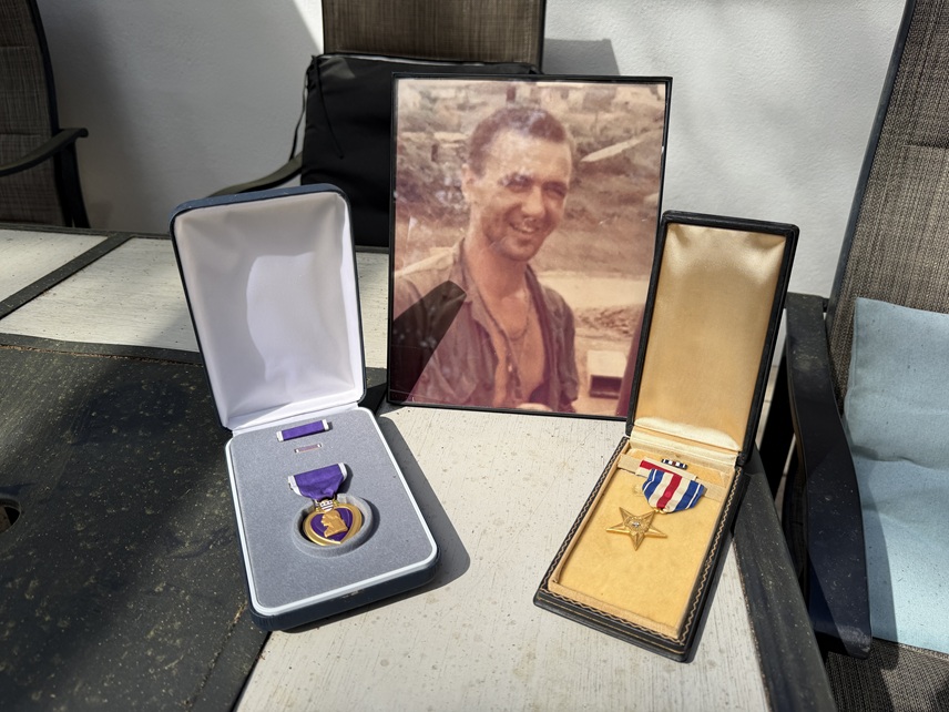 Stephen Kochick’s Silver Star and Purple Heart displayed alongside his wartime portrait.